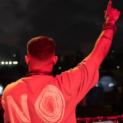 A shot from behind, showing my "NOBO" shirt while pointing to the sky. It's all about representing the brands and communities that support the music.