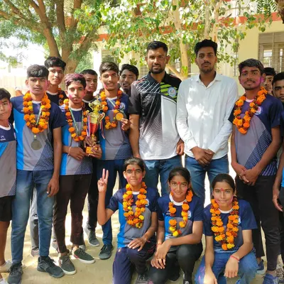Our victorious Mallakhamb team, including both boys and girls, posing with their trophy and medals. This group photo captures the collective spirit and success of the Vivekananda Sports Academy.