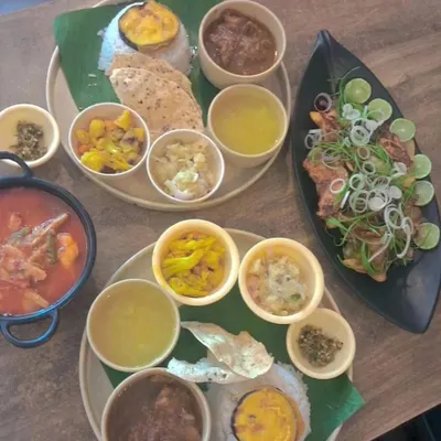 A beautiful spread of our different thalis and side dishes. Each thali is a balanced meal, offering a variety of tastes and textures, from spicy curries to simple boiled vegetables and tangy chutneys.