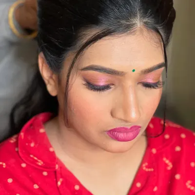 A behind-the-scenes close-up of a vibrant pink eye makeup look in progress. This shows the detail and precision that goes into every makeup application.