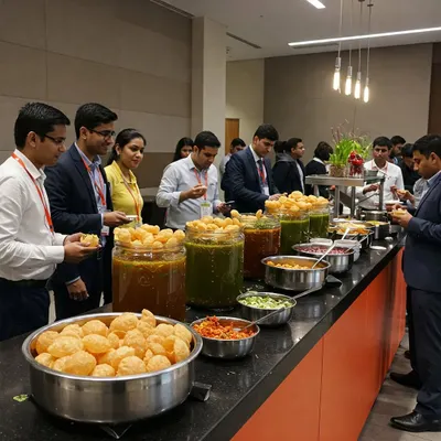 A long line of happy employees at a corporate party enjoying our interactive pani puri station. Our live counters are a proven way to boost morale and encourage team bonding.