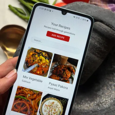 A look at the Nivaala app on a phone, surrounded by real kitchen ingredients. It shows how technology can fit seamlessly into the traditional process of cooking and sharing recipes.