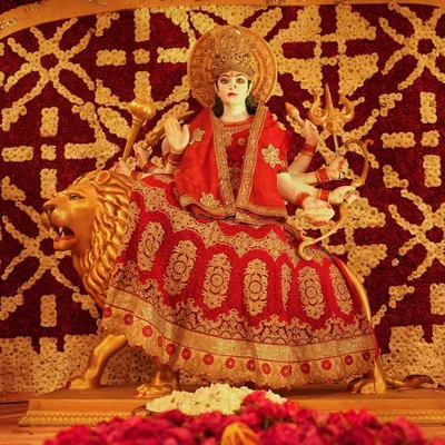 For this Durga Puja, the deity was framed by an intricate backdrop made entirely of red and gold flowers. We used thousands of blooms to create a traditional pattern, providing a rich and reverent setting for the goddess.