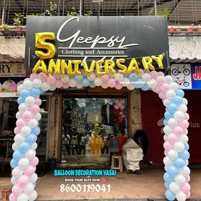 For the 5th anniversary of a clothing store, I set up this welcoming balloon arch right at the entrance. The design uses soft pink, blue, and white balloons with large gold foil letters to attract customers and celebrate the occasion.