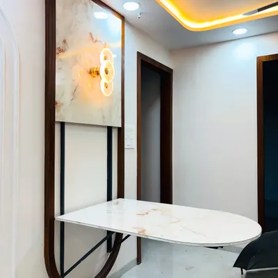 A perfect example of our space-saving furniture: a wall-mounted dining table. This unit features a marble-finish top that folds down, supported by a sturdy metal frame, and is complemented by a decorative backlit panel above.