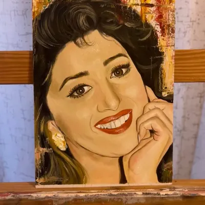 A finished oil portrait of the actress Madhuri Dixit on a canvas sheet, set against an abstract, textured background. I focused on capturing her iconic smile and expressive eyes.