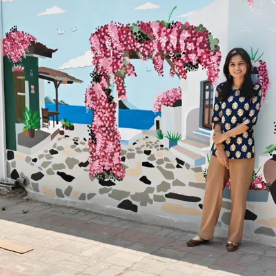 The full view of the expansive European streetscape mural I painted for The Herbs on Fire restaurant. This large-scale artwork transforms an outdoor wall into a picturesque scene.
