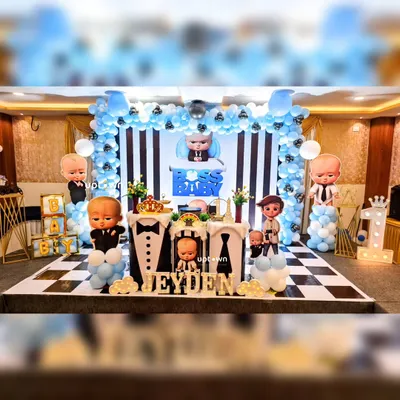Our Boss Baby theme is perfect for a stylish first birthday. This setup features a black and white striped backdrop, a checkerboard floor, and multiple cutout's of the Boss Baby character's, creating a fun and formal look.