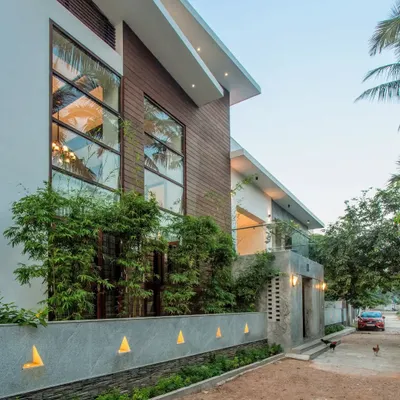 The renovated facade of the Eco Terre residence. We retained the original plinth of the 33-year-old home and built a new, modern structure that incorporates large windows and natural materials like wood and stone.