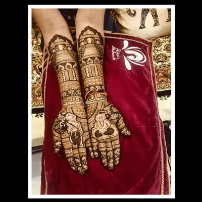 A special mehendi design for a mother celebrating her son's Munj, or thread ceremony. The palms feature a 'batu' (young Brahmin boy) and other traditional elements.