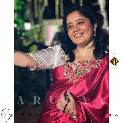 Every saree has a story. I'm wearing a new-age satin saree with a custom-designed white blouse featuring a beautiful bird motif embroidered on the neckline.