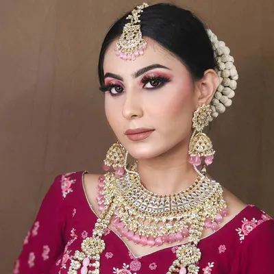 This look features a beautiful pink lehenga paired with a matching pink-beaded Kundan jewellery set, perfect for a soft and romantic bridal shoot.