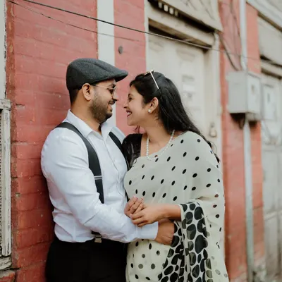 A sweet moment from a retro-themed shoot in the old lanes of Pune. The vintage-style clothing and the classic architecture create a timeless feel.