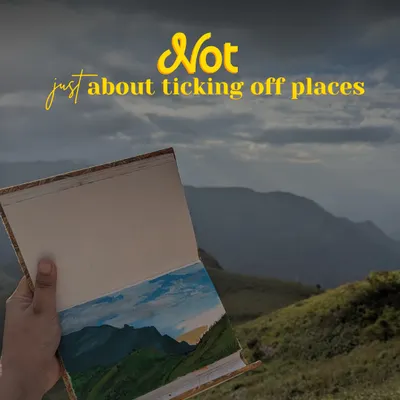 This isn't about ticking off places; it's about the experience. This image from our off-beat Kodai trip shows a hand holding a painted journal against the hills, capturing the soul of the journey.