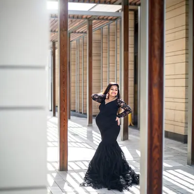 A stunning solo portrait in Dubai, using modern architecture and dramatic shadows to create a high-fashion maternity look.