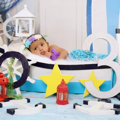 A wider view of the 'Little Mermaid' theme, showing the complete nautical setup. The boat prop, stars, and the number '3' for a 3-month milestone make this a detailed and adorable scene.