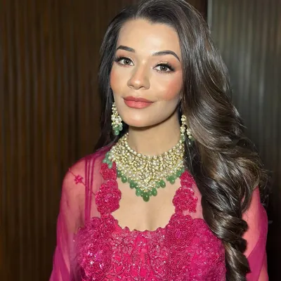 Drenched in red, glowing in glam. This look for Tanisha features a warm smokey eye and luminous skin, perfect for an evening celebration.
