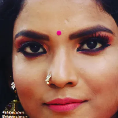 A close-up showcasing a warm, smokey eye with sharp eyeliner and full lashes. This type of eye makeup adds drama and intensity, making it a popular choice for brides and for evening events.