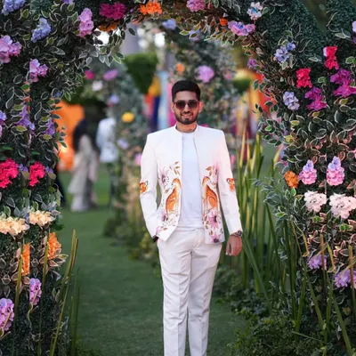 A full view of my hand-painted bandhgala zipper jacket, perfect for a daytime wedding ceremony. The custom artwork with birds and florals adds a unique, personal touch to the groom's ensemble, setting him apart with sophisticated style.