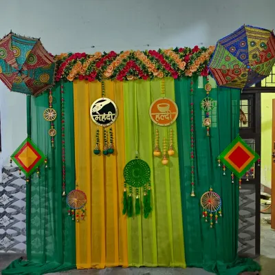 This is a classic Haldi and Mehndi backdrop I created for a joint ceremony. I used bright green and yellow drapes, Rajasthani umbrellas, and custom signs for both 'Haldi' and 'Mehndi' to create a balanced and festive look perfect for photos.