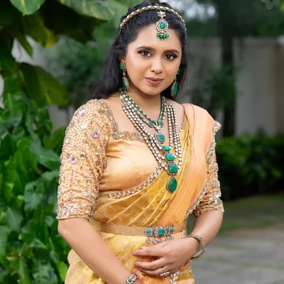 This look from my 'Athiloka Sundari' series features me in a pure Kanchi saree. I paired it with a blouse adorned with intricate embroidery and semi-precious stone embellishments, creating a regal outfit designed to make any bride feel like a princess.
