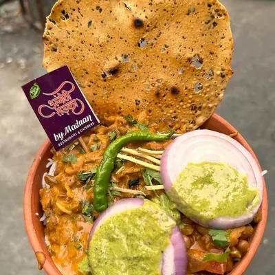 Our Rajma Chawal served in a traditional kulhad, topped with fresh onions, green chutney, and a crispy papad. This is the ultimate comfort food, full of authentic Punjabi flavor.