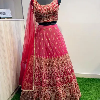 This Maharani pink lehenga is a showstopper, featuring dense gold embroidery on both the blouse and skirt. It's a timeless and elegant choice for a wedding guest who wants to make an impression.