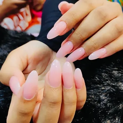 The definition of simple elegance. This is a beautiful set of long, almond-shaped nails with a semi-sheer pink gel overlay. It enhances the natural nail while providing strength and a flawless, glossy finish.