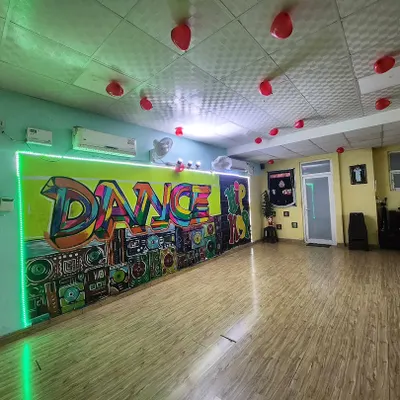 A wide view of our dance and fitness studio. The open layout, wooden floors, and colorful graffiti wall create a welcoming and motivating environment for every class.