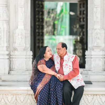 A couple celebrating their 50th anniversary, captured in a serene moment at a temple. I love creating beautiful portraits that honor a lifetime of love and companionship.