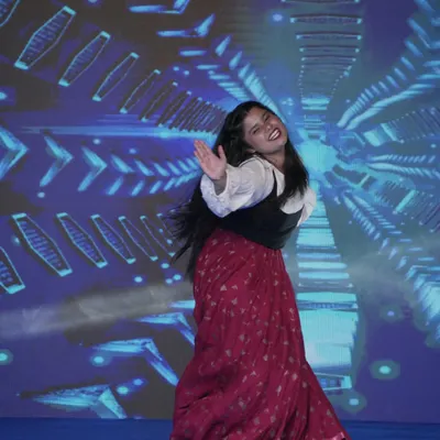 A student captivates the audience with an energetic dance performance during a YMCA event. We encourage all our students to participate and express their creativity.