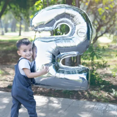 That happy smile says he is two. Using large number balloons is a fun and classic way to mark a birthday milestone during our outdoor photoshoots.