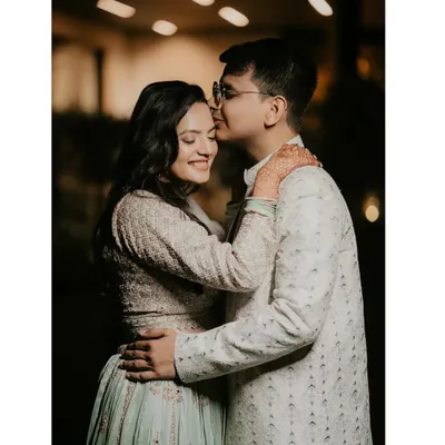A sweet and intimate moment from a roka ceremony. The groom's gentle kiss on his fiancée's forehead perfectly captures the love and excitement of this special day.