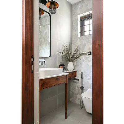 This powder room features one of my favorite custom design elements: a solid wood vanity with spindle legs and an arched scallop detail. It creates an immediate wow-moment and perfectly captures the home's Modern Spanish state of mind.
