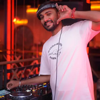 In my element, headphones on, hand on the deck. This is my office. I'm focused on the mix, ensuring every transition is smooth and the energy keeps building.