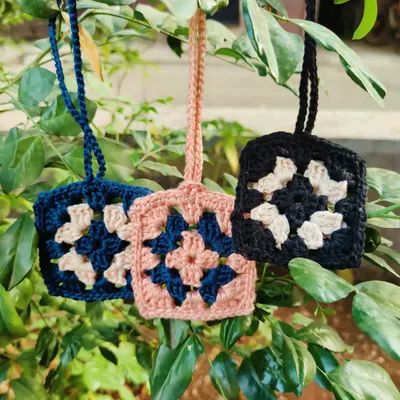 Keep your Airpods safe from scratches with our handmade crochet cases. This photo shows our popular granny square design, available in multiple color combinations.