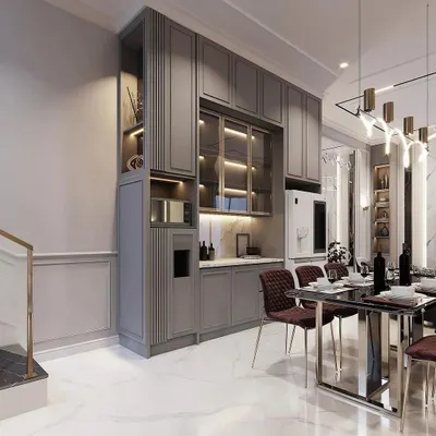 This elegant, floor-to-ceiling crockery unit in a matte grey finish provides extensive storage. It features a mix of closed cabinets, glass-fronted display sections with internal lighting, and a dedicated niche for a microwave or coffee machine.