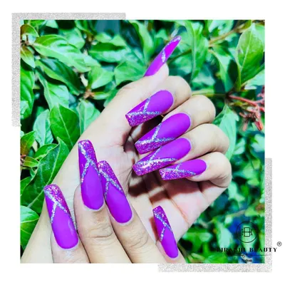 This look is all about drama. I used a rich, matte purple gel polish as the base and added intersecting lines of silver glitter for a striking contrast and texture.