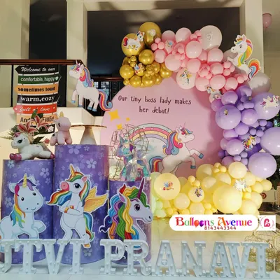 A magical unicorn-themed birthday party, perfect for a "tiny boss lady's debut." This setup features unicorn cutouts, a rainbow backdrop, and themed pedestals.