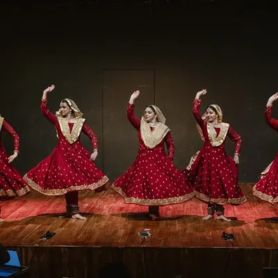 My dancers in a classic Kathak pose during a performance. The traditional costume, with its wide flare, is designed to accentuate the beauty of the spins and movements.