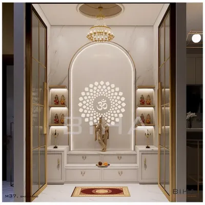 This pooja room design demonstrates our ability to create modern sacred spaces. We used white marble for its purity, framing an arched niche with soft, integrated lighting. The backlit 'Om' mandala creates a serene focal point, while glass doors with brass frames provide a sense of enclosure without sacrificing visual connection to the home.