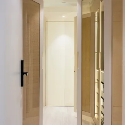 This is where my #BeyondKitchen approach comes to life. This walk-in closet was designed with the same care as a kitchen, with mirrored and wicker-paneled doors that create a space that feels light, textured, and deeply personal.
