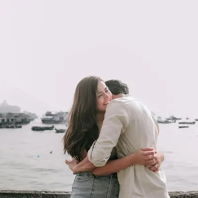 A warm, heartfelt hug with the boats at the Gateway of India in the background. This photo captures an intimate moment against one of Mumbai's most iconic waterfronts.