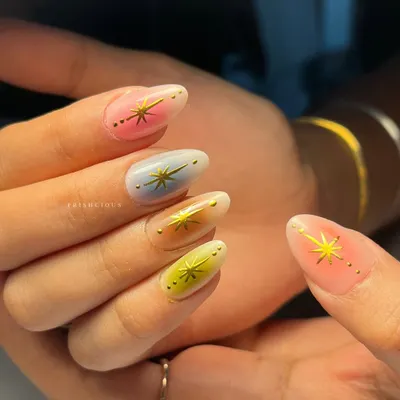 A close-up of these multi-color aura nails. Each nail has a different pastel base with a soft white aura effect, making them look like they're glowing from within.