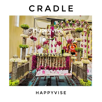 The cradle is the star of the naming ceremony. Here, an ornate silver cradle is beautifully decorated with garlands of fresh jasmine and purple flowers for a traditional 'thottilu shastra'.