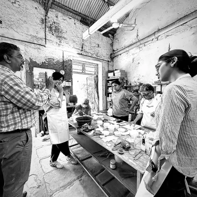 A moment from our masterclass on clay bodies and glazes. Here, I am discussing techniques with participants in the middle of our working studio, surrounded by the tools and materials of the craft.