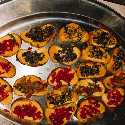 A platter of assorted bruschetta, a perfect light and flavorful appetizer for any corporate networking event or party.