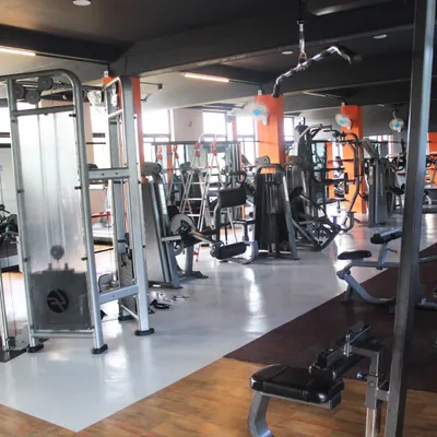 A wide view of our strength training floor, packed with a variety of branded machines. We have everything you need to target every muscle group for a comprehensive workout.