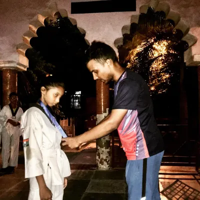 A proud moment as I award a medal to a student after the North Districts Taekwondo Championship. Recognizing their hard work is an important part of their journey.