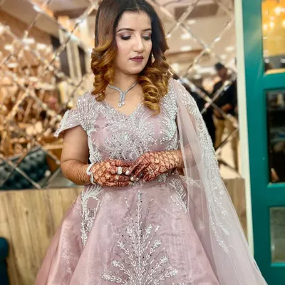 This client is ready for her engagement in a breathtaking dusty pink gown. We created a soft glam makeup look with defined eyes and styled her hair in voluminous curls to match the romantic feel of her outfit.